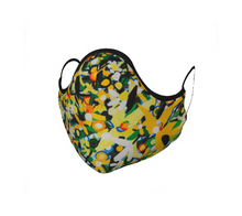 Load image into Gallery viewer, This 100% cotton face mask is yellow, green, white and blue with black edging and black cloth ear ties. The bright and floral pattern is semi abstract and based on Annika Connor&#39;s Avalon oil painting. The mask has ties which first you knot to adjust to best fit your face, then you loop around your ears. The face mask itself covers your nose, mouth, and goes under your chin. The inside of the mask has matching 100% cotton fabric which creates a pocket for you to be able to insert a filter of your choice. 

